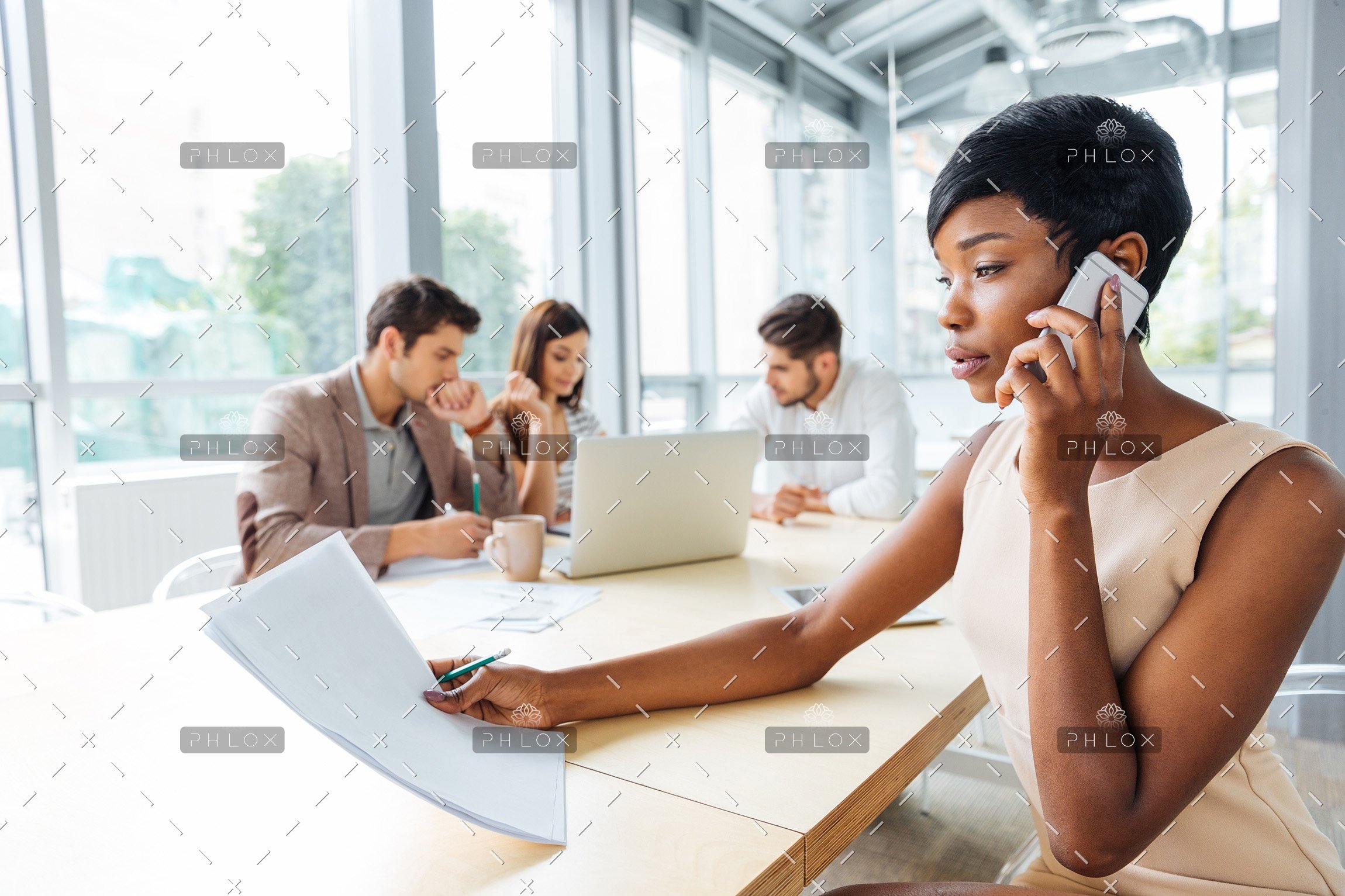 serious-businesswoman-with-documents-talking-on-P9Q6LX6